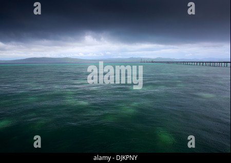 Rain and dark storm clouds over tropical ocean in the Raja Ampat Islands, West Papua Stock Photo