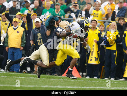 Sept. 11, 2010 - South Bend, Indiana, USA - University of Michigan receiver Martavious Odoms is hauled down by Notre Dame cornerback Darrin Walls Saturday September 11, 2010 at Notre Dame Stadium in South Bend, Indiana.  Michigan beat Notre Dame 28-24. (Credit Image: © Jim Z. Rider/ZUMApress.com) Stock Photo