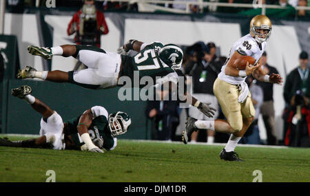 Sept. 18, 2010 - East Lansing, Mi, USA - Notre Dame quarterback Dayne Crist escapes Michigan State's Johnathan Strayhorn Saturday September 18, 2010 at Spartan Stadium in East Lansing, Michigan.  Michigan State beat Notre Dame 34-31. (Credit Image: © Jim Z. Rider/ZUMApress.com) Stock Photo