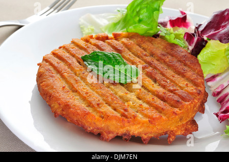a veggie burger in a plate on a set table Stock Photo