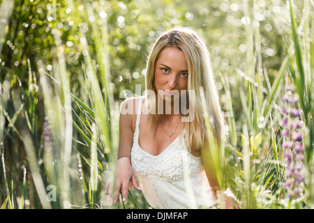 Blond young woman in a grass close-up. Stock Photo