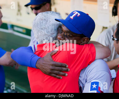 Texas Rangers manager Ron Washington, front right, greets Adrian