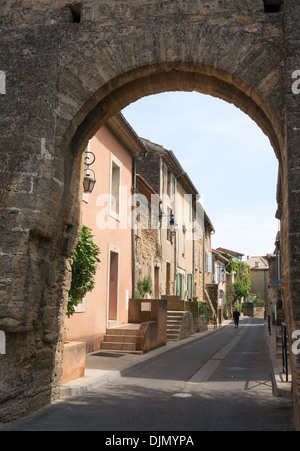 Woman walking along street in Chateauneuf du Pape, France, Europe Stock Photo