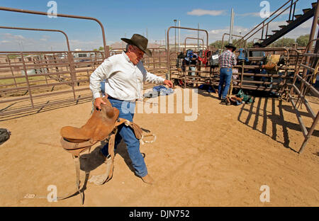 Oct 03, 2008 - Las Vegas, Nevada, USA - RICK MILLER, of Emporia, Kansas, totes his saddle to the chutes, where he will compete in saddle bronc riding at the National Senior Pro Rodeo Association circuit stop in Las Vegas.  Male and female rodeo performers age 40 plus compete for NSPRA prize money in sanctioned events throughout the year across 20 US states and three Canadian provin Stock Photo
