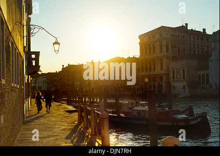 Couple walking on quay in the old town of Venice Stock Photo