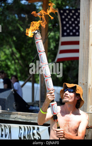Mar 11, 2008 - East Dublin, Georgia, USA - Preston Wright lights the beer can torch during the opening ceremonies of the 13th annual Summer Redneck Games at Buckeye Park in East Dublin, Georgia, on Saturday. The annual homage to Southerners, began as a spoof to the 1996 Summer Olympics in Atlanta. Thousands of revelers attend the event whose events include bobbing for pigs feet, th Stock Photo