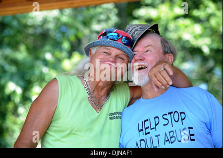 Mar 11, 2008 - East Dublin, Georgia, USA - Frank 'Freight Train' Mills, left, hugs a visitor during the opening ceremonies of the 13th annual Summer Redneck Games at Buckeye Park in East Dublin, Georgia, on Saturday. The annual homage to Southerners, began as a spoof to the 1996 Summer Olympics in Atlanta. Thousands of revelers attend the event whose events include bobbing for pigs Stock Photo