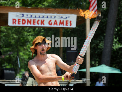 Mar 11, 2008 - East Dublin, Georgia, USA - Preston Wright holds the beer can torch during the opening ceremonies of the 13th annual Summer Redneck Games at Buckeye Park in East Dublin, Georgia, on Saturday. The annual homage to Southerners, began as a spoof to the 1996 Summer Olympics in Atlanta. Thousands of revelers attend the event whose events include bobbing for pigs feet, the Stock Photo