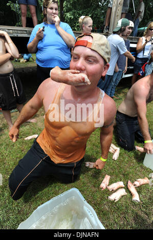 Mar 11, 2008 - East Dublin, Georgia, USA - Jeremiah Hatfield competes in the Bobbing for Pigs Feet event during the 13th annual Summer Redneck Games at Buckeye Park in East Dublin, Georgia, on Saturday. The annual homage to Southerners, began as a spoof to the 1996 Summer Olympics in Atlanta. Thousands of revelers attend the event whose events include bobbing for pigs feet, the mud Stock Photo