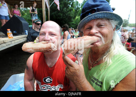 Mar 11, 2008 - East Dublin, Georgia, USA - Bobbing for Pigs Feet winner Eric Outler, left, celebrates with Frank 'Freight Train' Mills during the 13th annual Summer Redneck Games at Buckeye Park in East Dublin, Georgia, on Saturday. The annual homage to Southerners, began as a spoof to the 1996 Summer Olympics in Atlanta. Thousands of revelers attend the event whose events include  Stock Photo