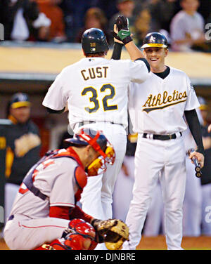 Oakland Athletics' Jack Cust, right, gets a handshake from third base coach  Tony DeFrancesco after Cust hit a two-run home run off Texas Rangers' Eric  Hurley in the first inning of a