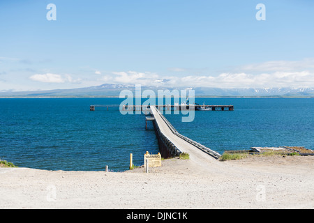 The dock at the town of Cold Bay on the Alaska Peninsula stretching out into Cold Bay in summer; Alaska USA Stock Photo