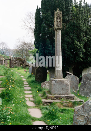 St Issui's Church, Partrishow, Powys: churchyard preaching cross beside a paved public footpath running alongside the church. Stock Photo