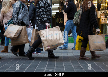 Primark 100% natural biodegradable brown paper women's fashion discount clothing store reusable shopping bags being carried by shoppers in Liverpool, UK Stock Photo