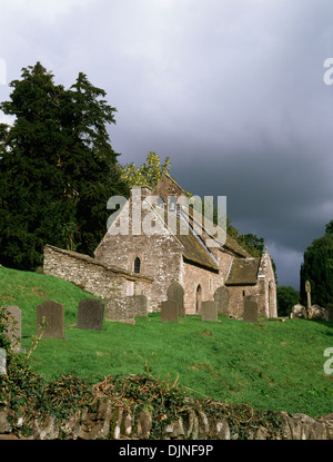 St Issui's Church, Partrishow, Powys, founded c 1060, showing L-R the stable, shrine chapel, nave, porch and churchyard preaching cross. Stock Photo