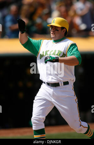 Oakland Athletics' Jack Cust, right, gets a handshake from third base coach  Tony DeFrancesco after Cust hit a two-run home run off Texas Rangers' Eric  Hurley in the first inning of a