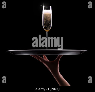 waiter hand with champagne on black background Stock Photo