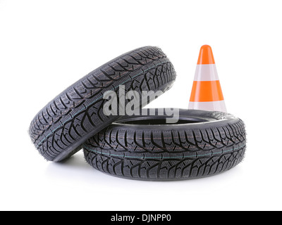 Two winter car tires and road cone shot on white Stock Photo