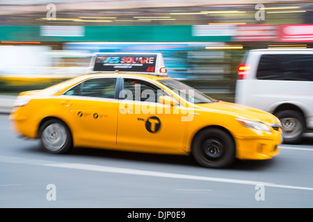 NEW YORK, US - NOVEMBER 21: Motion blurred shot of famous New York yellow taxi. November 21, 2013 in New York. Stock Photo