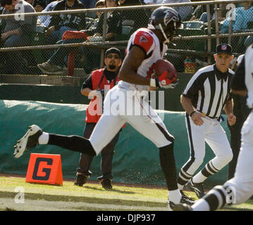 Oakland Raiders wide receiver Michael Crabtree (15) catches a pass in front  of Denver Broncos cornerback Bradley Roby (29) during the first half of an NFL  football game in Oakland, Calif., Sunday