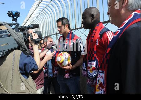 Mar 19, 2010 - Manhattan, New York, USA - Red Bulls' defender MIKE PETKE speaks to the media as goalkeeper BOUNA CANDOUL (C) and head coach HANS BACKE (R) look on as they tour the Empire State Building as the New York Red Bulls celebrate the grand opening of their new arena in Harrison, New Jersey with an exhibition game against Brazil's FC Santos tomorrow night.  (Credit Image: Â© Stock Photo