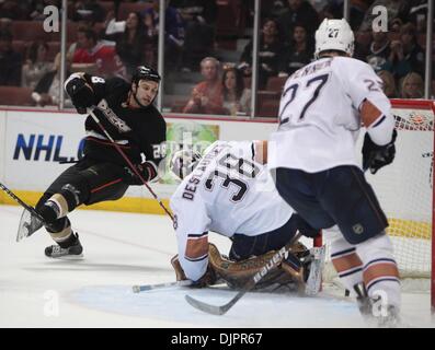 Apr 11, 2010 - Anaheim, California, USA - Anaheim Ducks' right center Kyle Chipchura, left, scores against Edmonton Oilers' goalie Jeff Deslauriers, center, and left wing Dustin Penner (27)during the third period of an NHL Hockey game at Honda Center. (Credit Image: © Mark Samala/ZUMA Press) Stock Photo