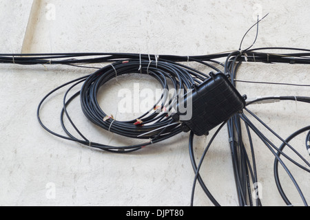 Fiber Optic spare cable roll and cable joint on a wall Stock Photo