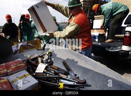 May 27, 2010 - Memphis, TN, U.S. - 27 may 10 (mwguns) Photo by Mark Weber - Employee's with NUCOR Steel Company and the Shelby County Sheriff's office toss roughly 50 guns into a front end loader so they can be transferred to a furnace to be melted down Thursday afternoon in South Memphis. All the guns were used during a crime and have been altered or damaged. A new state law direc Stock Photo