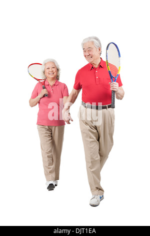 Senior couple holding tennis rackets Stock Photo