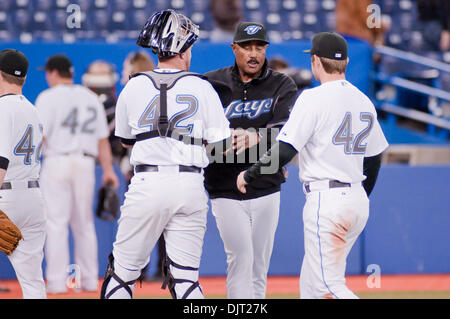 Apr. 15, 2010 - Toronto, Ontario, Canada - 15 April 2010 Toronto, Ontario:  Toronto Blue Jays manager, Cito Gaston (center) celebrates with catcher John Buck #14 (left) and Toronto Blue Jays second baseman Mike McCoy #18 after their victory over the Chicago White Sox by a score of 7-3, at Rogers Centre in Toronto, Ontario. (Credit Image: © Darren Eagles/Southcreek Global/ZUMApress. Stock Photo