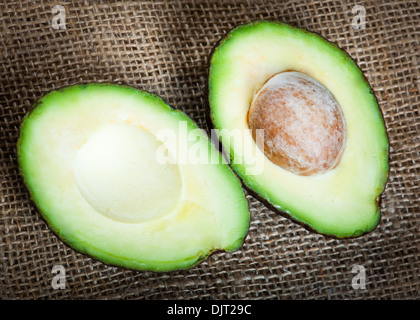Ripe avocado on a wooden board in the studio Stock Photo