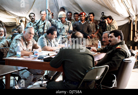 US Gen. H. Norman Schwarzkopf, commander-in-chief, U.S. Central Command, dictates conditions for a cease-fire to combat operations to Iraqi Generals during talks March 3, 1991 in Safwan, Iraq. Next to Gen. Schwarzkopf is Lt. Gen. Khalid Bin Sultan Bin Abdul Aziz, right, commander of Joint Forces in Saudi Arabia and across the table Iraqi Lt. Gens. Mohammd Abdez Rahman Al-Dagitistani and Sabin Abdel-Aziz Al Douri. Stock Photo