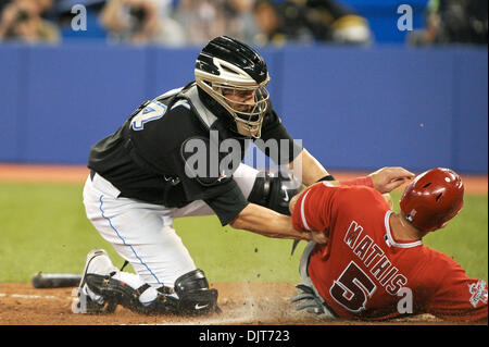 Apr. 18, 2010 - Toronto, Ontario, Canada - 18 April 2010: Toronto Blue Jays catcher John Buck (14) blocks the plate successfully as Los Angeles Angels Jeff Mathis (5) slides into him in the 9th inning. The Angels defeated the Blue Jays 3-1 at the Rogers Centre in Toronto, Ontario. (Credit Image: © Adrian Gauthier/Southcreek Global/ZUMApress.com) Stock Photo