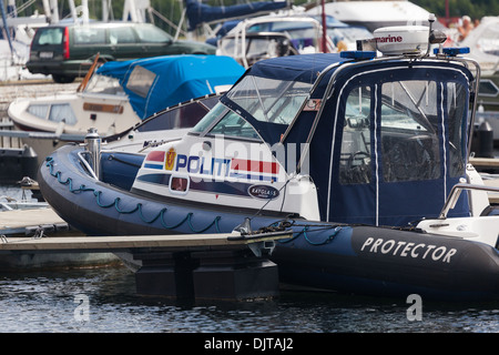 Waterfront  marina development of old Fishing port Kristiansand Norway with police patrol boat moored alongside Stock Photo