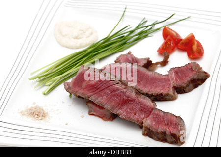 Grilled wagyu rump steak, served with chives, cherry tomatoes, sea salt, and horseradish source. Stock Photo