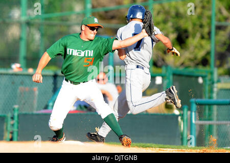 Miami Hurricanes 1B Ryan Perry (51) waits for throw to make play on St. Thomas University Bobcats INF Lance Larimer (7). The 14th ranked Miami Hurricanes defeated the St. Thomas University Bobcats 9-6 at Alex Rodriguez Park in Coral Gables, Florida. (Credit Image: © Ron Hurst/Southcreek Global/ZUMApress.com) Stock Photo