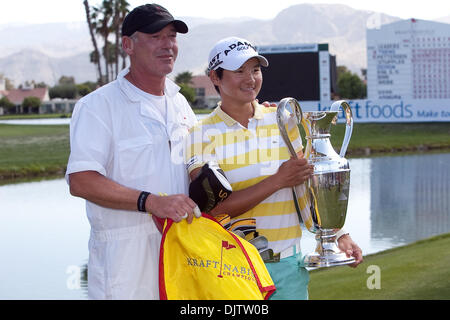 Yani Tseng (right) pictured with her caddy Dave Poitevent (left) and trophy after winning the championship of the  39th Kraft Nabisco Championship held at Mission Hills Country Club in Rancho Mirage, California. (Credit Image: © Gerry Maceda/Southcreek Global/ZUMApress.com) Stock Photo