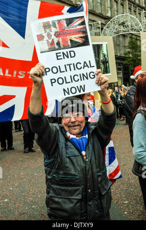 Belfast, Northern Ireland - 30th Nov 2013 - A man holds up a poster calling for the end of political policing Credit:  Stephen Barnes/Alamy Live News Stock Photo