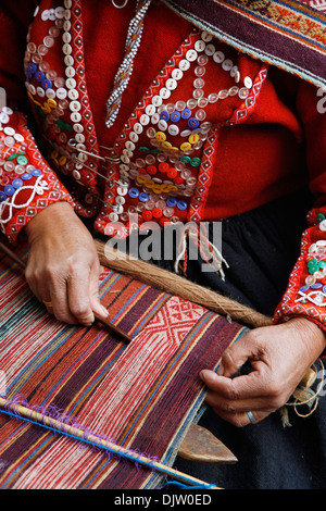 Quechua women weaving a traditional textile, Cuzco, Peru. Stock Photo