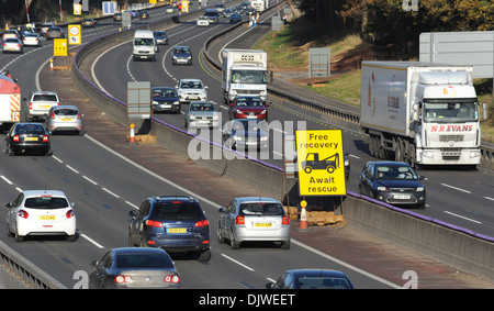 TRAFFIC TRAVELLING IN ROADWORKS SECTION OF THE M6 MOTORWAY WITH FREE BREAKDOWN RECOVERY SIGN SPEED LIMIT 50MPH CAMERAS GATSO UK Stock Photo