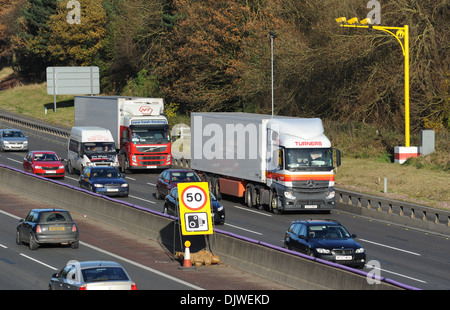 TRAFFIC TRAVELLING IN ROADWORKS SECTION OF THE M6 MOTORWAY WITH SPEED LIMIT 50MPH SIGN CAMERAS SAFETY MOBILE GATSO UK Stock Photo
