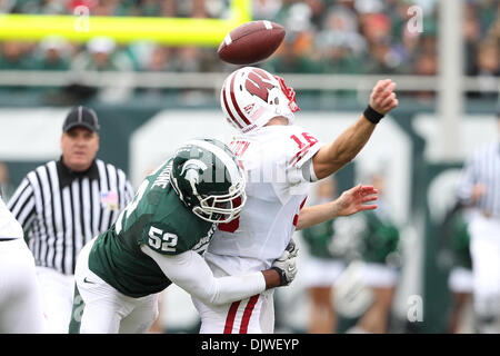 Oct. 2, 2010 - East Lansing, Michigan, United States of America - Michigan State Spartans defensive end Denzel Drone (52) knocks the ball losse from Wisconsin Badgers quarterback Scott Tolzien (16) at Spartan Stadium. (Credit Image: © Rey Del Rio/Southcreek Global/ZUMApress.com) Stock Photo