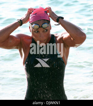 Oct 09, 2010 - Kailua-Kona, Hawaii, U.S. - A female competitor emerges from the tough 2.4 mile swim leaving the water for the bicycle stage during the 2010 Ford Ironman World Championship from Kailua-Kona. (Credit Image: © L.E. Baskow/ZUMApress.com) Stock Photo