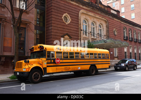 Thomas International type C yellow school bus parked outside Baltimore School for the Arts, Mount Vernon district, Maryland, USA Stock Photo