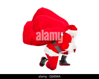 santa claus carrying heavy gift bags Stock Photo