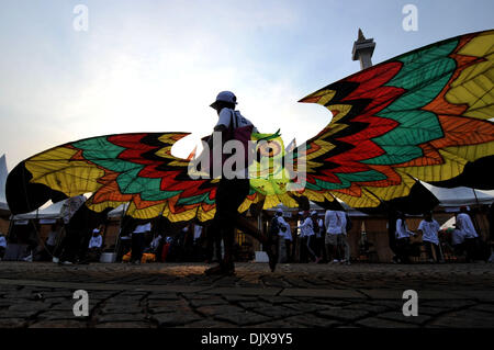 Jakarta, Indonesia. 1st Dec, 2013. A participant flies a kite during the Jakarta International Kite Festival 2013 in Jakarta, Indonesia, Nov. 30, 2013. The two-day festival opened on Saturday, with the participation of 18 countries and regions. Credit:  Agung Kuncahya B./Xinhua/Alamy Live News Stock Photo