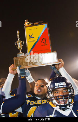 Nov. 17, 2010 - Toledo, Ohio, United States of America - Toledo Rockets players hold the Peace Pipe trophy aloft as they celebrate their victory at the end of the game.  Toledo defeated arch-rival Bowling Green 33-14 at the Glass Bowl in Toledo, Ohio in the annual Battle for the Peace Pipe. (Credit Image: © Scott Grau/Southcreek Global/ZUMApress.com) Stock Photo