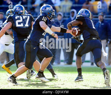 Nov. 26, 2010 - Pittsburgh, Pennsylvania, United States of America - 26 November 2010: Pittsburgh Panther QB Tino Sunseri (#12) hands off to RB Ray Graham (#1) in2nd half action at Heinz Field in Pittsburgh Pennsylvania. West Virginia defeats Pittsburgh 35-10. (Credit Image: © Paul Lindenfelser/Southcreek Global/ZUMAPRESS.com) Stock Photo