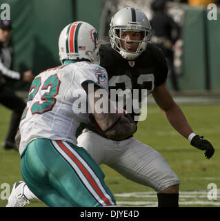 Nov. 28, 2010 - Oakland, CA, USA - Oakland Raiders vs Miami Dolphins at Oakland-Alameda County Coliseum Sunday, October 10, 2010.  Oakland Raiders safety Tyvon Branch #33 tackles Miami Dolphins running back Ronnie Brown #23..Raiders loose to Dolphins 33-17 (Credit Image: © Al Golub/ZUMAPRESS.com) Stock Photo