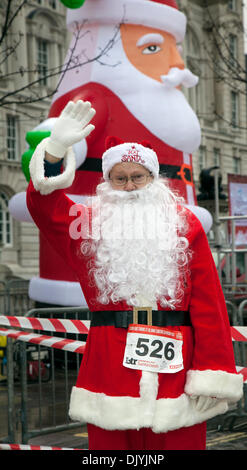 Liverpool, Merseyside, UK  1st December, 2013. Warren Foster, 50 from Warrington at the Liverpool Santa Dash starting at the Pier Head and attempting to break the Guinness World Record for the ‘Largest Santa Gathering’ which stands at a staggering 13,000 and also trying to raise to more than last years total of £5 million.  Festive Fun Run is backing the ITV Text Santa Appeal this year to help raise funds for Age UK, Anthony Nolan, Carers UK, Marie Curie Cancer Care, Together for Short Lives and Whizz-Kidz. Stock Photo